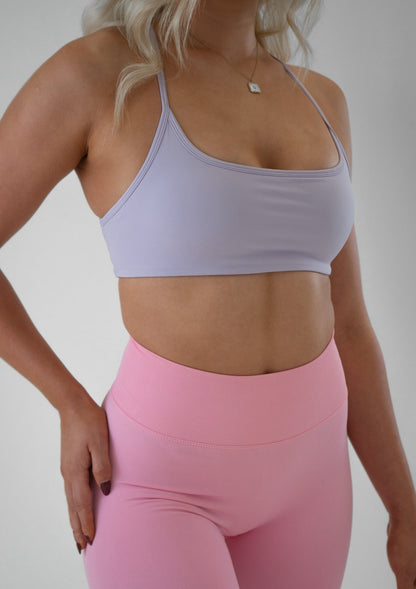 Model wearing a lilac activewear bra and pink leggings set