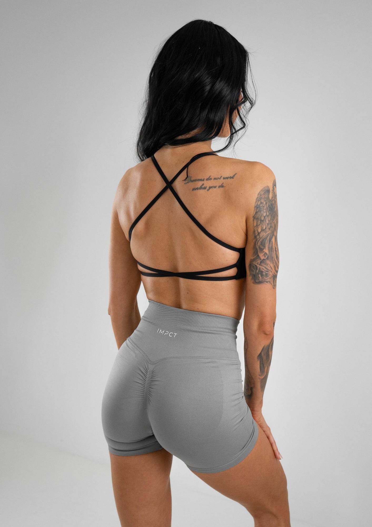 Model wearing a black activewear bra with grey shorts set