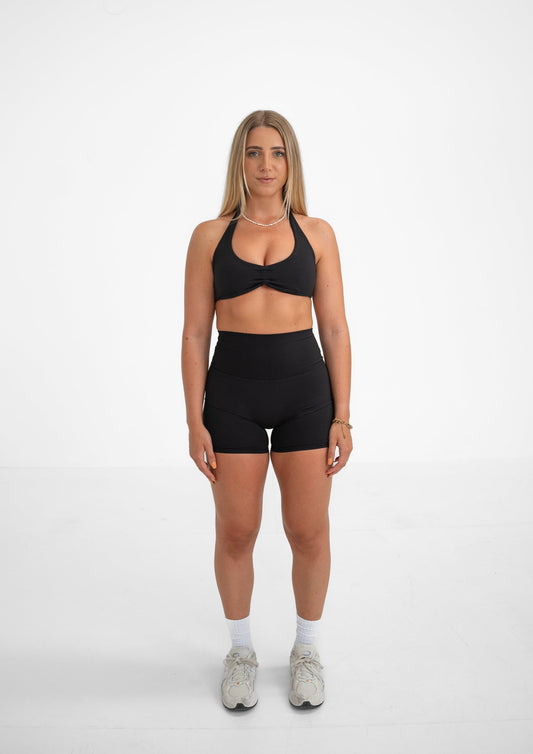 Model wearing a black activewear set